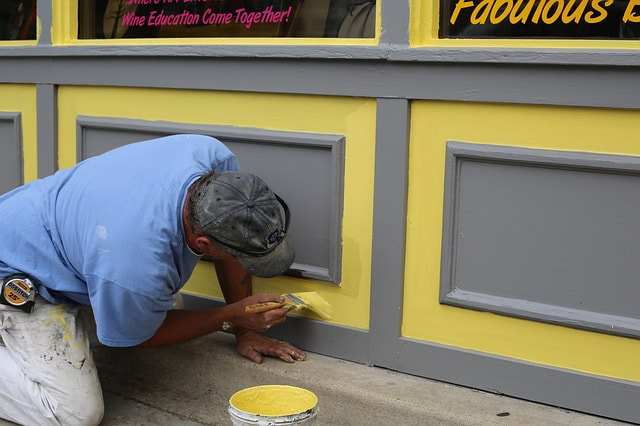picture of a professional painter painting the exterior of a commercial building